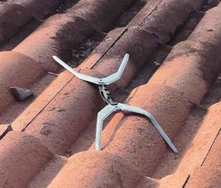 Revealing mysteries unveiling the secrets of enigmatic objects - #19 I just noticed this strange X shaped thing on my roof. I have no idea what it's made of. It has some sort of a hinge or clasp in the middle. Any ideas?