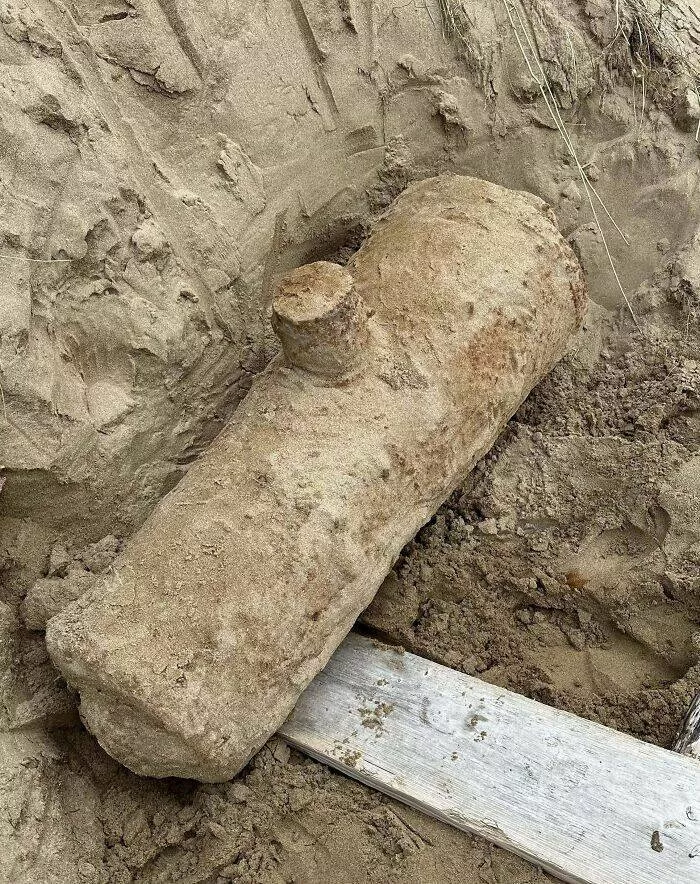 Puzzling enigmas unveiling the mystery objects that left everyone scratching their heads - #18 I dug this up while on holiday in Devon, UK. Only the protruding cylindrical part was visible, and it was found ~7m up a sand dune. It is solid metal (most likely iron) and roughly a meter in length. It didn't seem hollow and was unbelievably heavy. Any i