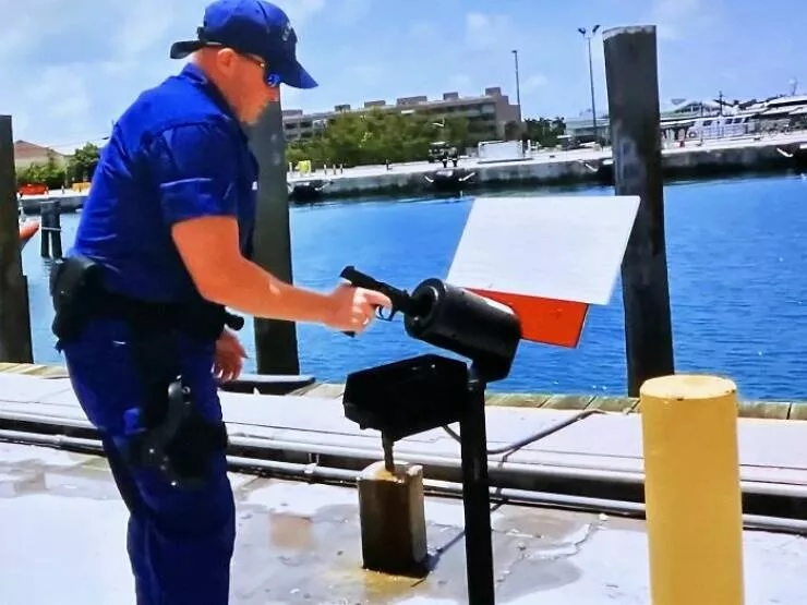 Puzzling enigmas unveiling the mystery objects that left everyone scratching their heads - #21 What is this tube that this Coast Guard guy sticks his gun into while loading it?