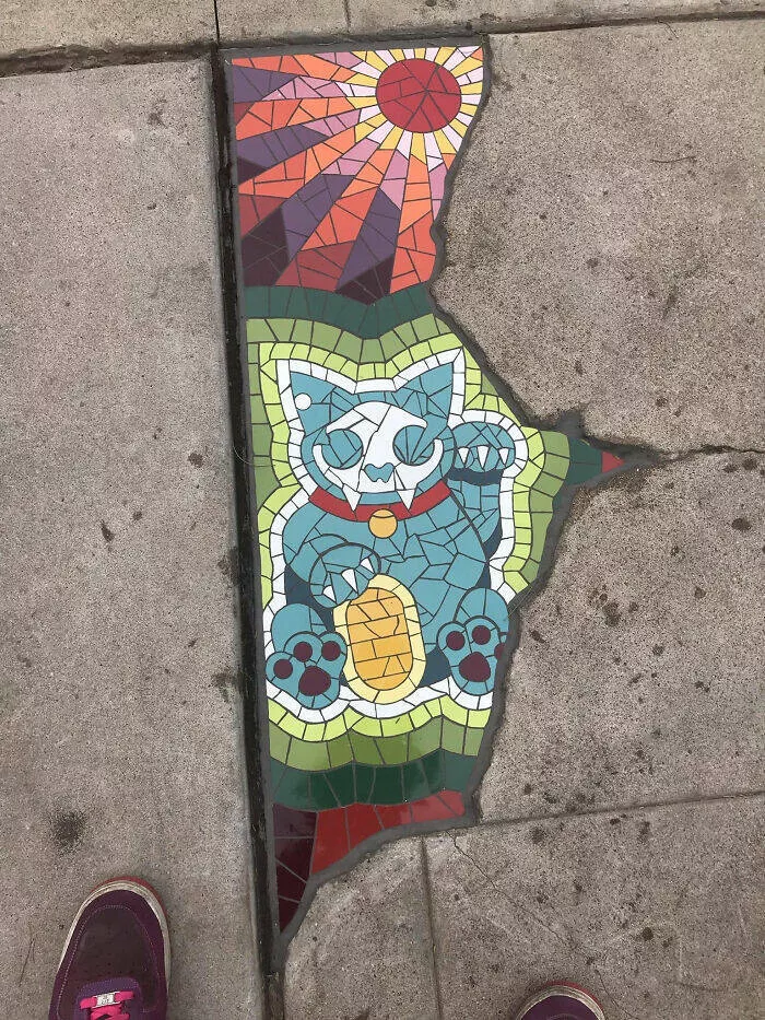 Intriguing discoveries subtly surprising finds that captivate - #33 A crack in the pavement filled with a stained glass portrait of a cat