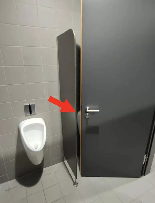 Design fails when creativity misses the mark - #7 A urinal positioned just within the swing range of the bathroom door