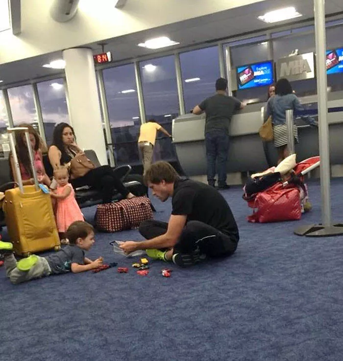 Airport anarchy wild photos that break all the rules - #7 After a 3-hour delay for plane issues, everyone was angry, but this guy on the floor playing cars with his son melted my heart