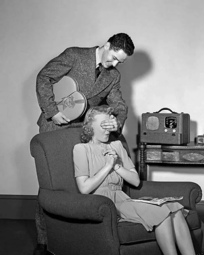 Unveiling hidden histories rare photos that tell untold stories - #34 Teen Boy With Hand Over Girl Eyes Surprising Her With Box Of Valentines Day Candy, 1940s