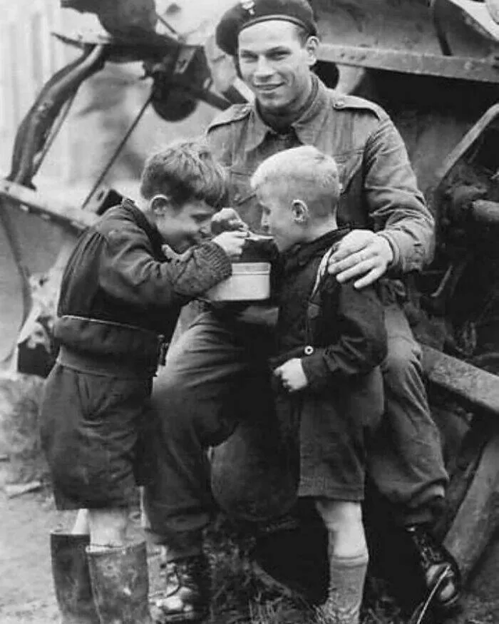 Unveiling hidden histories rare photos that tell untold stories - #9 A soldier sharing his food with two Dutch children, 1945