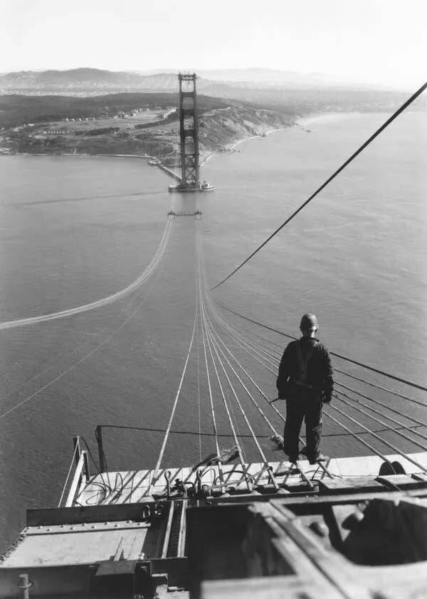 Intriguing images of historical construction projects - #15 A man standing on the first cables during the Golden Gate Bridge construction.