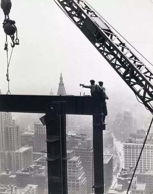 Intriguing images of historical construction projects - #16 Members of a derrick crew adjusting a beam during the Empire State Building's construction, with New York streets far below.