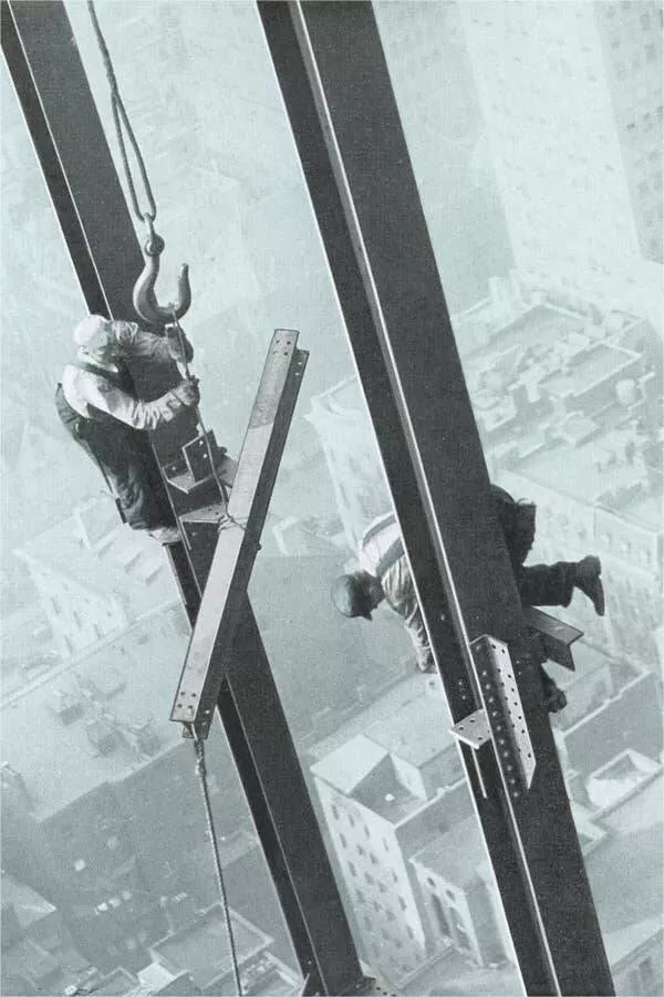 Intriguing images of historical construction projects - #17 Observing two steelworkers as they skillfully maneuver girders into place during the construction of a skyscraper.