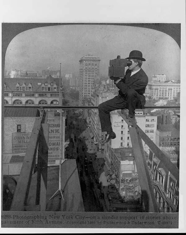 Intriguing images of historical construction projects - #32 A photographer balances eighteen stories above Fifth Avenue while he uses a stereoscopic camera to take pictures of the city.