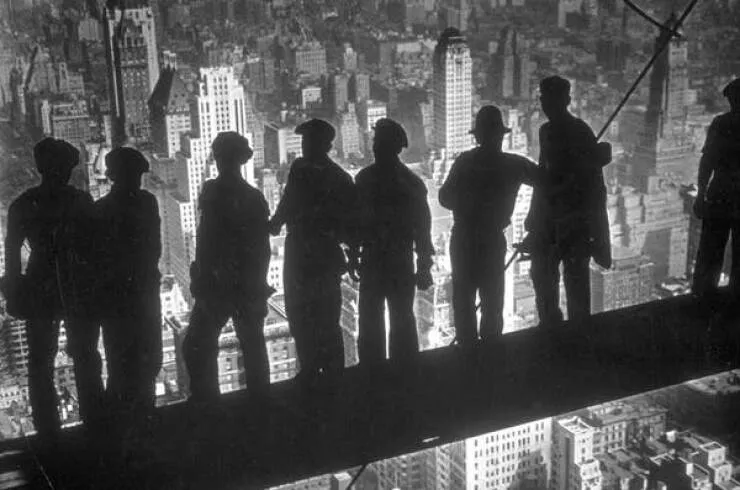 Intriguing images of historical construction projects - #8 A group of steelworkers standing on scaffolding 70 stories up, overlooking New York City from the RCA building.
