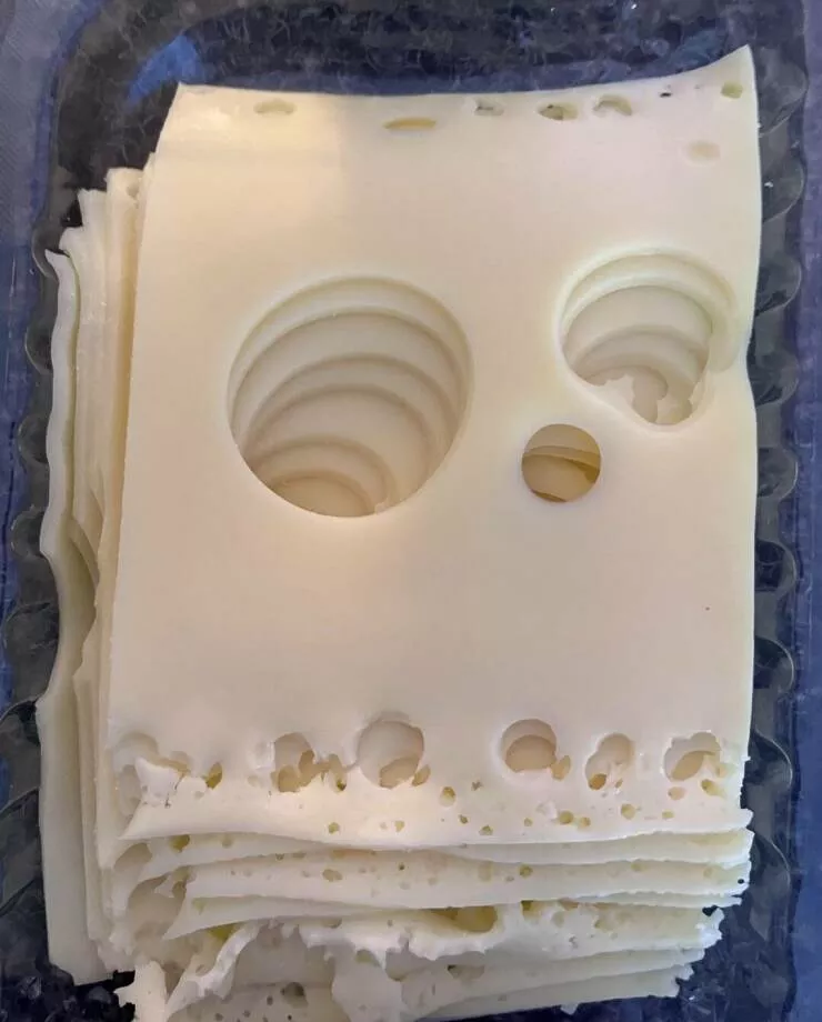 Intriguingly curious photos that ignite your interest - #13 Opened a pack of cheese slices today and was greeted by this spooky face.