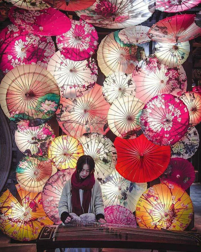 Photos that show how unique china really is - #12 A serene moment captured of a girl playing the Guzheng in Chengdu, Sichuan
