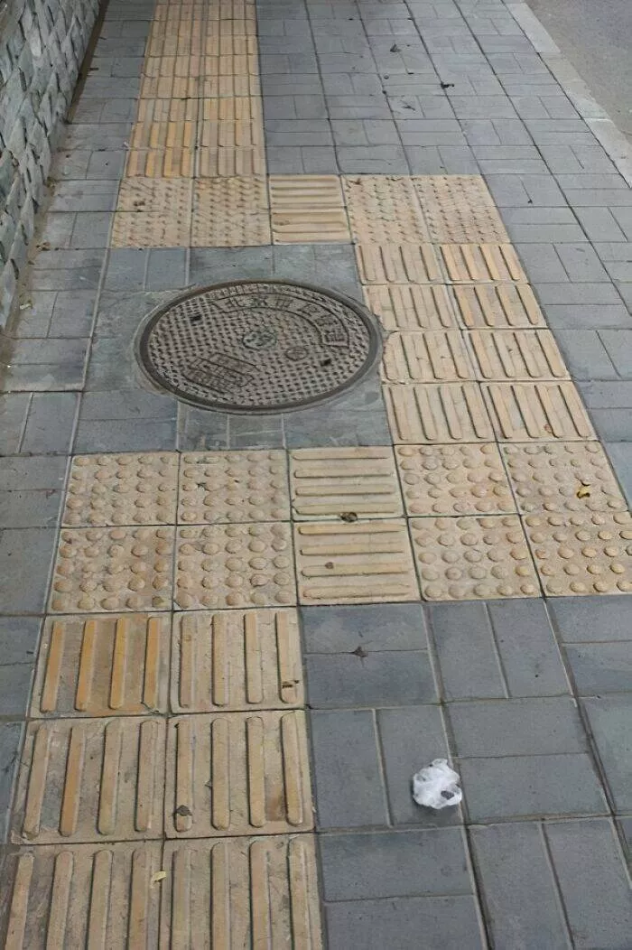 Photos that show how unique china really is - #44 In Beijing, tactile paving for the blind sometimes leads around manholes due to cultural superstitions