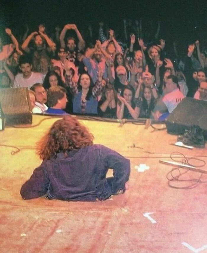 Nostalgic 90s photos that capture the decades unique vibes - #28 Eddie Vedder of Pearl Jam smashing through the stage at the Boston Garden Arena, 1994