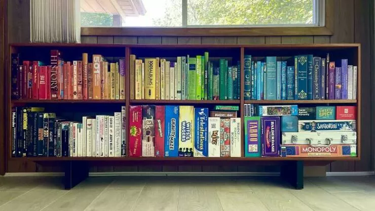Neatly arranged things thatll calm your soul - #13 My Airbnb’s Book and Game Shelf