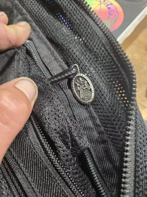 Hunting everyday hidden treasures - #11 A St. Christopher medal (patron saint of travelers) tucked inside the pocket of my ICONMOTO motorcycle jacket.