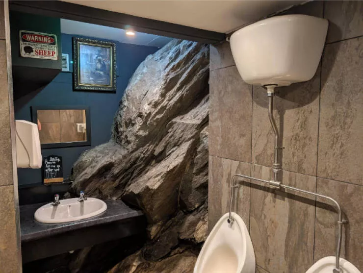 Awesome pics that get better the longer you look - #1 Pub Bathroom Designed Around Natural Rock Formation