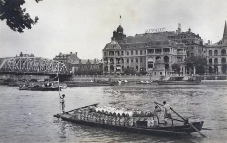 Vintage photos uncovering hidden world stories - #13 Freight Barge Navigates Past Russian Consulate in 1919 Shanghai