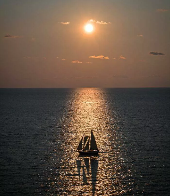 Against all odds stories of incredible fortune - #7 I managed to capture this beautiful sailboat at sunset from my hotel room