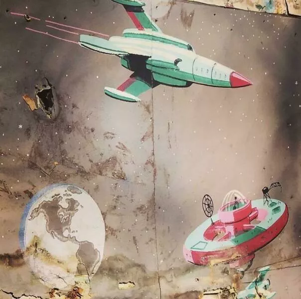 Unusual finds unearthed inside forgotten houses - #21 Behind layers of old wallpaper in a farmhouse, we found a retro space-themed design—hello, cosmic nostalgia!