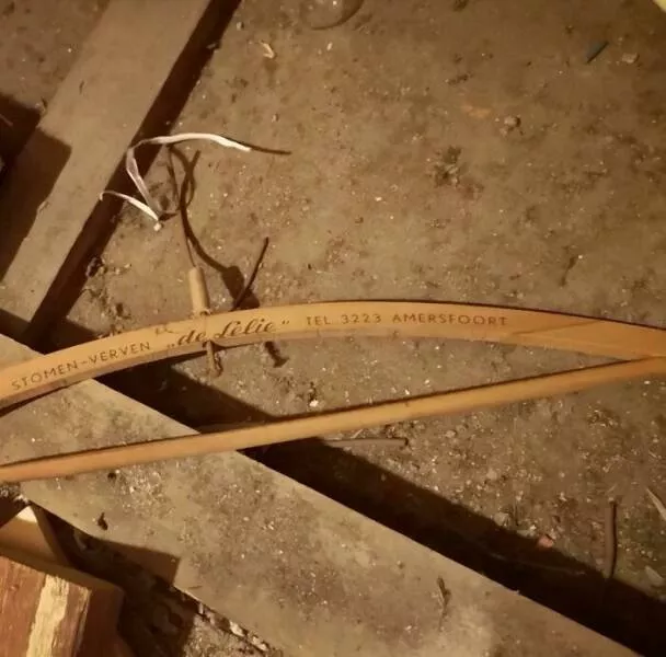 Unusual finds unearthed inside forgotten houses - #41 This antique clothes hanger was hiding between floorboards—its company phone number only has four digits!