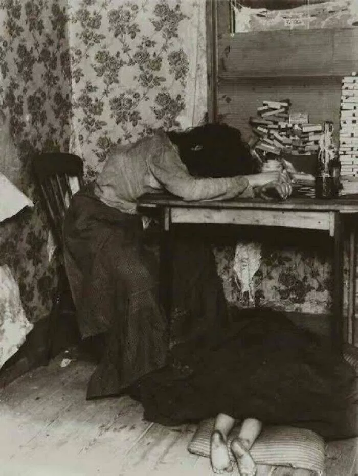 Photos and facts that change your perspective - #33 Mother making matchboxes with child sleeping under table Photos and facts that change your perspective - #33 Mother making matchboxes with child sleeping under table